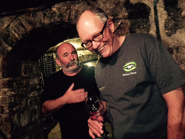 Scott and Thierry joking and tasting wine in cellar